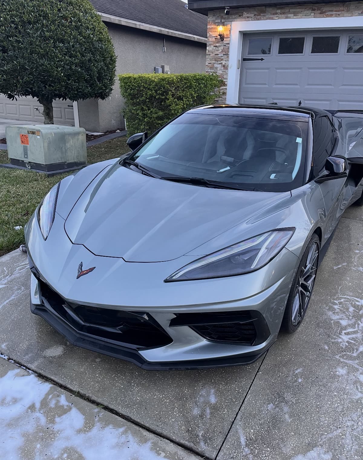 Silver Corvette C8 freshly detailed inside and out in a driveway