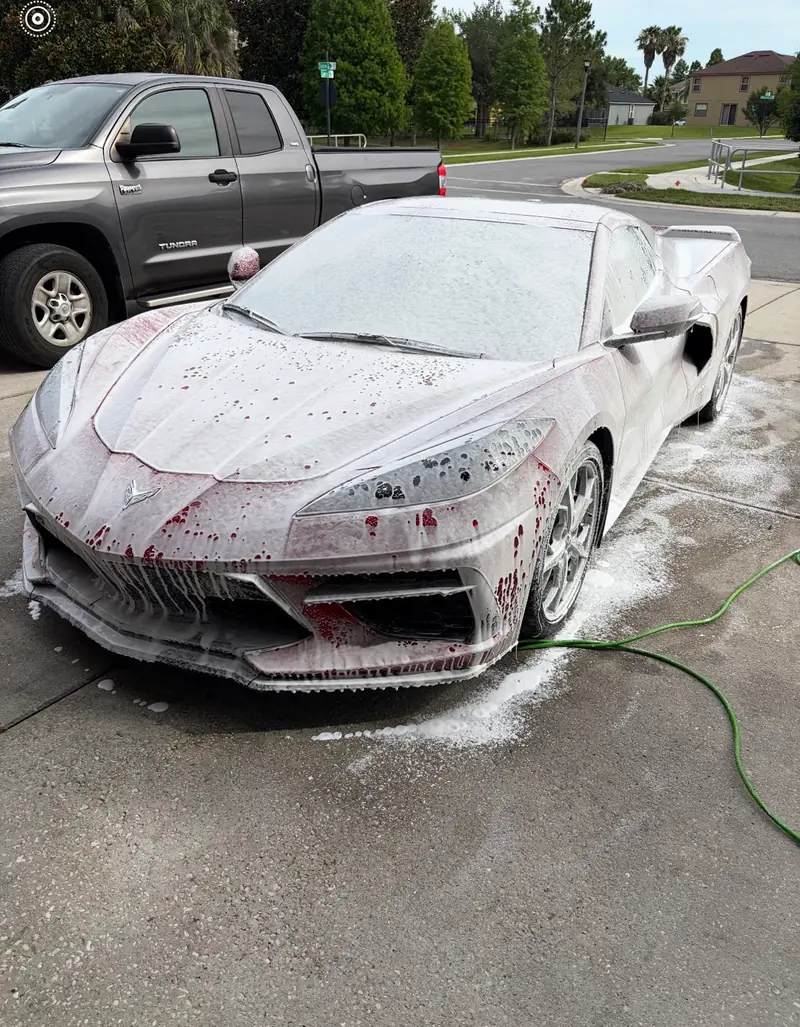 Corvette C8 covered in thick snow foam during a PureVisions pre-wash