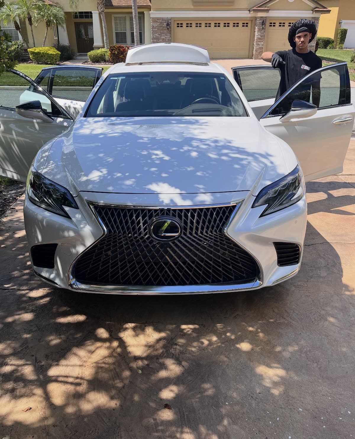 PureVisions detailer presenting a finished white Lexus LS