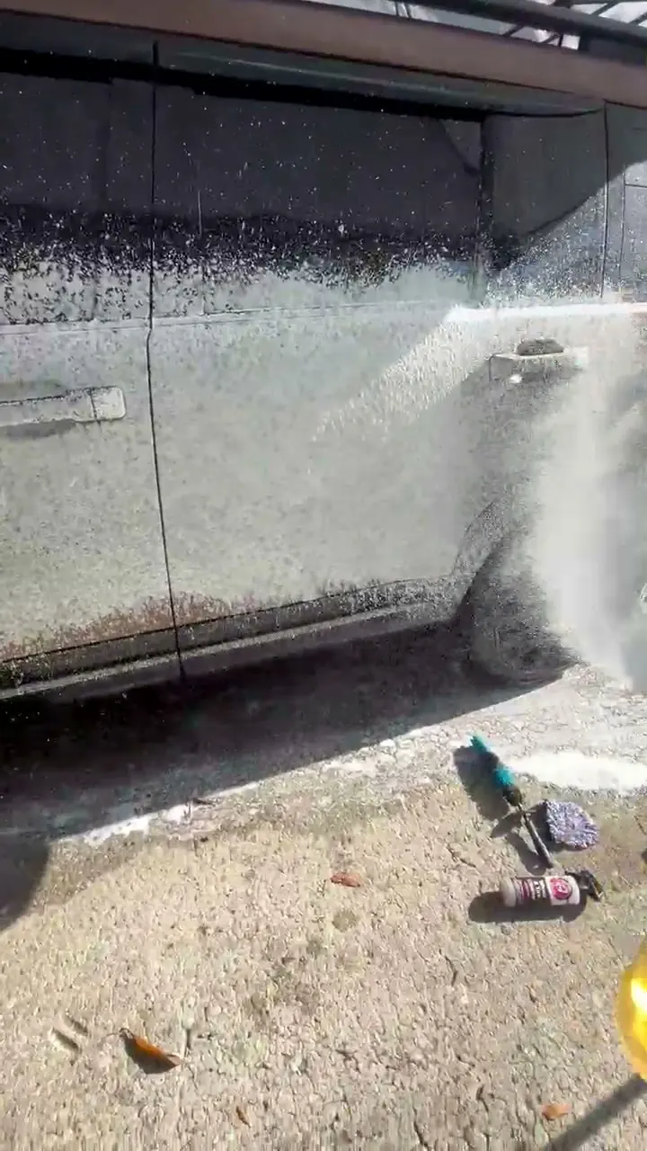 Snow foam clinging to an SUV side panel